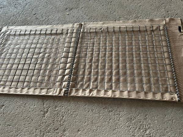 A piece of back panel of defensive barrier pro on the ground.
